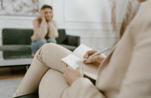 po czym poznać dobrego terapeutę, psychoterapeuta notujący na kanapie podczas sesji